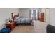 Cozy main bedroom with soft carpeting, a wooden bed frame, and a window with bright natural light at 13765 Whiskey Daisy Dr, Dade City, FL 33525