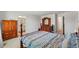 Spacious main bedroom with ample natural light, wooden furniture, and ensuite bathroom access at 13765 Whiskey Daisy Dr, Dade City, FL 33525