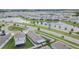 An aerial view of the community with a lake, green spaces, and several single-Gathering homes at 1398 Crescent Hoop Way, Wesley Chapel, FL 33543