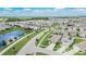 Expansive community view featuring homes, landscaping, and a pond under a blue sky at 1398 Crescent Hoop Way, Wesley Chapel, FL 33543