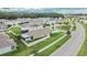 An aerial view of the house showing the backyard, and neighborhood with tree lined streets at 1398 Crescent Hoop Way, Wesley Chapel, FL 33543
