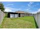 A view of the home's fenced backyard with a screened-in patio and well-maintained lawn at 1398 Crescent Hoop Way, Wesley Chapel, FL 33543