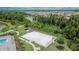 View of a full-sized basketball court and lush green landscaping near the community pool at 1398 Crescent Hoop Way, Wesley Chapel, FL 33543
