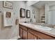 Bathroom with double sink vanity, framed mirrors, and neutral tones create a relaxing space at 1398 Crescent Hoop Way, Wesley Chapel, FL 33543