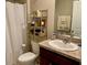 Cozy bathroom with a shower/tub combination, neutral colors, and storage shelving at 1398 Crescent Hoop Way, Wesley Chapel, FL 33543