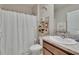Bathroom featuring a shower with a curtain, toilet, and storage shelves at 1398 Crescent Hoop Way, Wesley Chapel, FL 33543