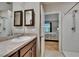 En-suite bathroom with vanity, shower, and a view into the adjacent bedroom at 1398 Crescent Hoop Way, Wesley Chapel, FL 33543