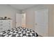 Well-lit bedroom features a patterned quilt, neutral wall color, and doorways leading to other areas at 1398 Crescent Hoop Way, Wesley Chapel, FL 33543