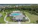 Aerial view of a community clubhouse with a large pool, sundeck, and basketball court for residents at 1398 Crescent Hoop Way, Wesley Chapel, FL 33543