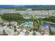 Overhead view of a large community pool with several lakes, lush landscaping, and recreational areas at 1398 Crescent Hoop Way, Wesley Chapel, FL 33543