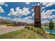 View of the Union Park entrance sign with beautiful landscaping, pond, and bright blue sky at 1398 Crescent Hoop Way, Wesley Chapel, FL 33543