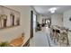 Inviting entryway with view to the dining area and modern decor touches create a warm welcome at 1398 Crescent Hoop Way, Wesley Chapel, FL 33543
