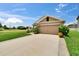 Charming single-story home with well-manicured lawn and a two car garage at 1398 Crescent Hoop Way, Wesley Chapel, FL 33543