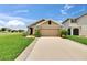 Charming single-story home with well-manicured lawn and a two car garage at 1398 Crescent Hoop Way, Wesley Chapel, FL 33543