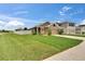 Charming single-story home with well-manicured lawn and a two car garage at 1398 Crescent Hoop Way, Wesley Chapel, FL 33543
