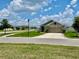 Well-maintained single Gathering home with a two-car garage, nice landscaping, and a green lawn at 1398 Crescent Hoop Way, Wesley Chapel, FL 33543