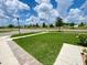 Grassy front yard with a clear view of the quiet street, adding to the home's appeal at 1398 Crescent Hoop Way, Wesley Chapel, FL 33543