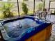 Backyard hot tub features a patio area with a table and chairs at 1398 Crescent Hoop Way, Wesley Chapel, FL 33543