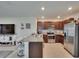 Open kitchen featuring stainless steel appliances, granite counters, and island, perfect for modern living at 1398 Crescent Hoop Way, Wesley Chapel, FL 33543