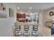 Open kitchen with stainless steel appliances, bar seating, and granite countertops at 1398 Crescent Hoop Way, Wesley Chapel, FL 33543