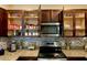 A kitchen with stainless steel appliances, granite counters, and wooden cabinets at 1398 Crescent Hoop Way, Wesley Chapel, FL 33543