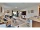 Open-concept living room with patio access and adjacent to the kitchen at 1398 Crescent Hoop Way, Wesley Chapel, FL 33543