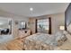 Bedroom with hardwood flooring and view of the ensuite bathroom at 1398 Crescent Hoop Way, Wesley Chapel, FL 33543