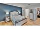 Bedroom featuring a deep blue accent wall and ensuite bathroom at 1398 Crescent Hoop Way, Wesley Chapel, FL 33543