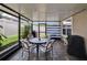 Cozy screened patio with an outdoor dining set, barbecue grill, and a lovely view of the backyard at 1398 Crescent Hoop Way, Wesley Chapel, FL 33543