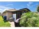 Exterior shot of the covered patio area, grill, and backyard of the home at 1398 Crescent Hoop Way, Wesley Chapel, FL 33543