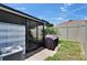 Exterior shot of patio, grill and backyard of home with screened in area at 1398 Crescent Hoop Way, Wesley Chapel, FL 33543