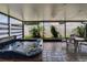 Inviting screened patio featuring a hot tub, comfortable seating, and lush landscaping for outdoor relaxation at 1398 Crescent Hoop Way, Wesley Chapel, FL 33543