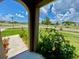 Scenic view from the front porch, showcasing the community's manicured landscaping and quiet street at 1398 Crescent Hoop Way, Wesley Chapel, FL 33543