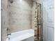 Bathroom with tiled tub and shower combo and stylish decor at 15860 Aurora Lake Cir, Wimauma, FL 33598