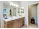 Bright bathroom featuring a sink with wooden cabinets, neutral walls, and stylish decor at 15860 Aurora Lake Cir, Wimauma, FL 33598