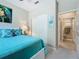 Charming bedroom featuring a blue-themed decor, sliding closet doors, and a glimpse of the bathroom at 15860 Aurora Lake Cir, Wimauma, FL 33598