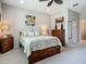 Relaxing bedroom featuring carpet, a ceiling fan, and neutral color scheme at 15860 Aurora Lake Cir, Wimauma, FL 33598