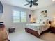 Bedroom featuring a ceiling fan, a window, and furniture at 15860 Aurora Lake Cir, Wimauma, FL 33598