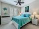 Bright bedroom features a comfortable queen-size bed and shuttered windows at 15860 Aurora Lake Cir, Wimauma, FL 33598