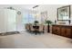 Inviting dining area with a modern light fixture and view of the front door at 15860 Aurora Lake Cir, Wimauma, FL 33598