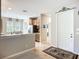 Bright entryway with tile flooring leading to the kitchen and dining area at 15860 Aurora Lake Cir, Wimauma, FL 33598
