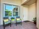 Charming front porch with seating area, potted plants, and a view of the front door at 15860 Aurora Lake Cir, Wimauma, FL 33598
