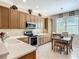 Modern kitchen featuring stainless steel appliances, light cabinetry, and a cozy breakfast nook at 15860 Aurora Lake Cir, Wimauma, FL 33598