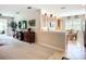 Bright, open-concept living space flowing into a modern kitchen and dining area at 15860 Aurora Lake Cir, Wimauma, FL 33598