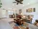 Cozy living room with sofas, and dining area, complemented by natural light at 15860 Aurora Lake Cir, Wimauma, FL 33598