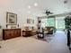 Living room showcasing a media center, comfortable seating, and a view of the lanai at 15860 Aurora Lake Cir, Wimauma, FL 33598