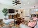 Open living room concept with entertainment center, dining area, and access to other rooms at 15860 Aurora Lake Cir, Wimauma, FL 33598