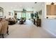 Spacious living room featuring comfortable seating and a large sliding glass door to the lanai at 15860 Aurora Lake Cir, Wimauma, FL 33598