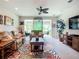 Bright living room featuring neutral walls, ceiling fan, and sliding glass doors to the lanai at 15860 Aurora Lake Cir, Wimauma, FL 33598