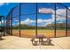 Fenced-in softball field in Valencia Lakes, with seating area and manicured playing surface at 15860 Aurora Lake Cir, Wimauma, FL 33598